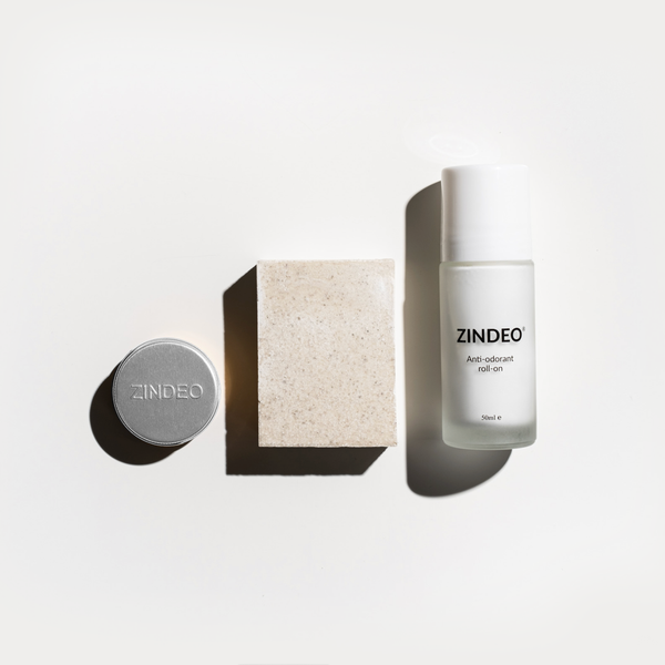 Zindeo 3-step starter set for anti-odorant, featuring a circular tin, a rectangular bar of soap, and a clear roll-on bottle labeled 'Zindeo Anti-odorant roll-on 50ml.' The products are arranged on a light background.